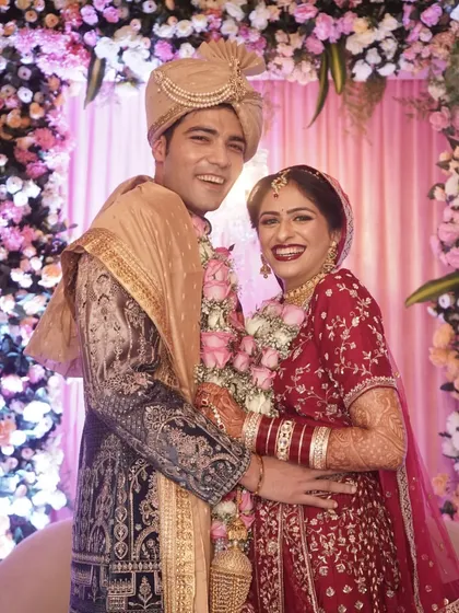 A joyful portrait of a newly married couple, their bright smiles lighting up the frame.