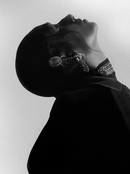 A black and white version from the 'Chrome' series, this image focuses on the silhouette and form. The pose, with the head tilted back, creates a dramatic and sculptural shape.