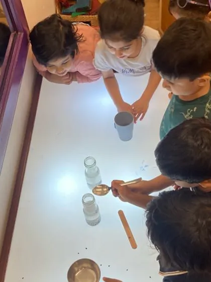 A simple science experiment with Eno and water captivates a group of young learners. They observe, predict, and collaborate, using language to describe the "bubbly" reaction. This is child-led scientific inquiry at its best.