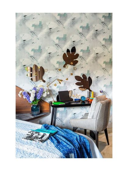This study nook features a playful, abstract wallpaper and unique leaf-shaped mirrors, turning a simple work corner into a creative and motivating space. We believe a workspace should do more than serve a function; it should inspire.