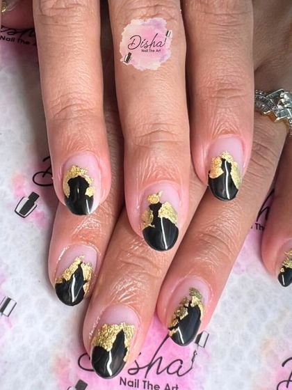 A bold and artistic design with black tips and gold foil accents on a sheer base.