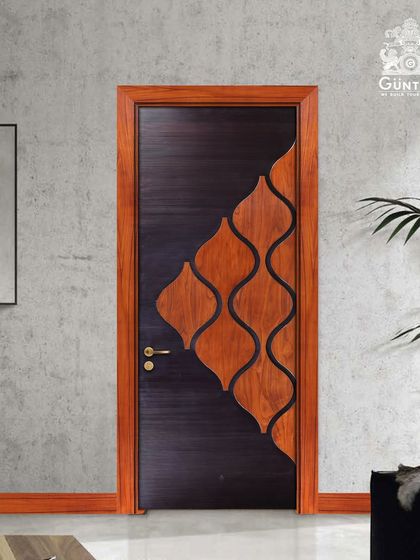 This designer door showcases a creative inlay pattern, where curved wood pieces are set against a dark, textured base. It's a playful yet sophisticated design that acts as a piece of art.