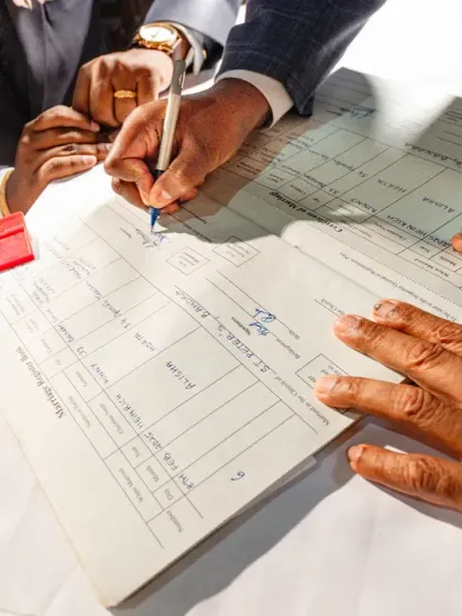 A detail shot of hands coming together to sign the wedding register. Hands can tell a powerful story of commitment and family.