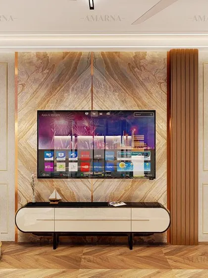 The entertainment wall in this lounge concept features a stunning bookmatched marble panel, flanked by wood and classic wall molding. This demonstrates our commitment to creating focal points where luxury is in the details.