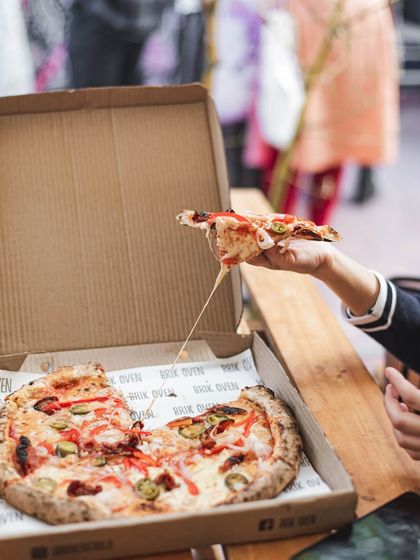 The ultimate cheese pull. This is the moment everyone waits for, showcasing the incredible melt of our fresh, handmade mozzarella.