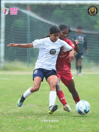 A fierce duel for the ball. This photo shows one of our players battling for possession, demonstrating the physical and competitive nature of the game.
