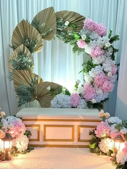 This beautiful setup combines soft pastel florals with modern boho elements like dried palm leaves, creating a trendy and romantic look for an engagement.