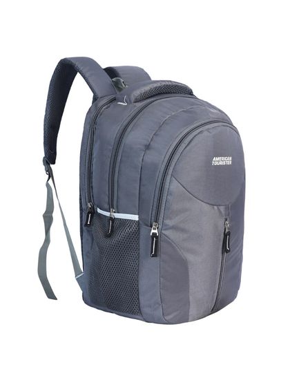 A three-quarter view of a grey backpack, showing its side profile and multiple compartments.
