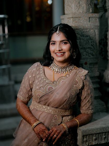 This reception look was all about elegance. I paired a soft, smoky eye with a neutral lip to complement her muted-tone lehenga, creating a sophisticated style for her evening event.