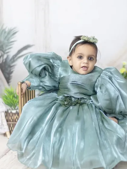 A fairytale princess in her beautiful gown. The greenery in the background adds a touch of an enchanted forest feel.