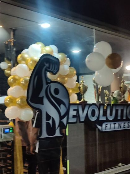 For the opening of Evolution Fitness, I created this gold and white balloon arrangement around their entrance. It's a great way to attract attention and create a celebratory atmosphere for a new business launch.