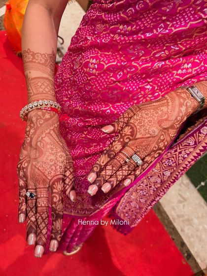 The 24-hour stain result on a bride, perfectly complementing her pink bandhani saree. You can see the rich, dark color that my natural henna produces.