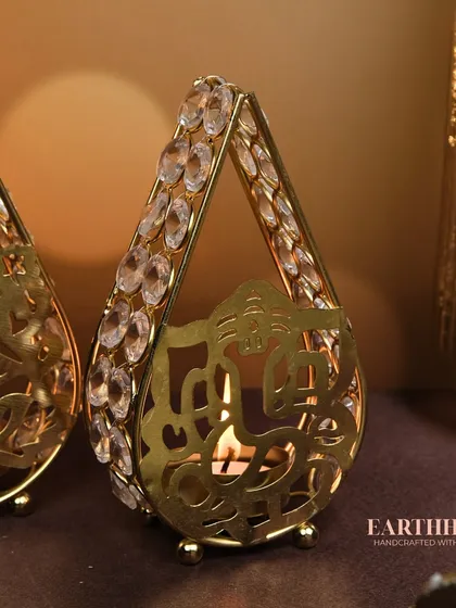 A side view of the Ganpati crystal tea-light holder, showing the intricate metalwork and sparkling crystals that catch the light so beautifully.