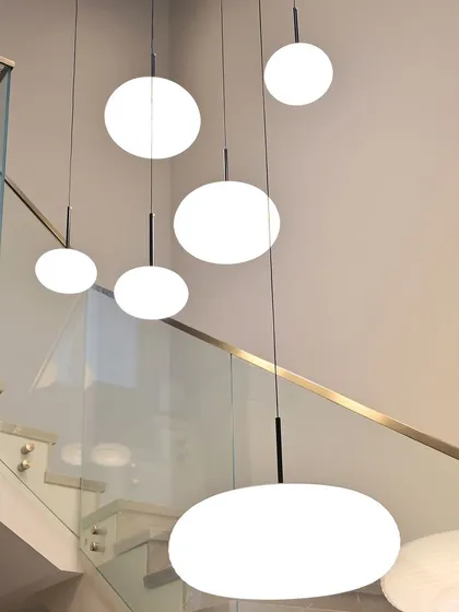 These cascading globe lights are a beautiful feature in a double-height space. I integrated them into the home's automation system for easy control and dimming.