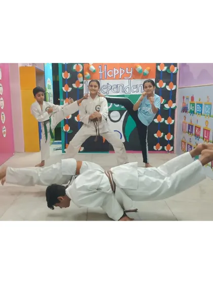 Our young warriors are a testament to the fact that discipline and strength have no age limit. This image captures our students demonstrating advanced bodyweight control and kicking techniques during a group session.