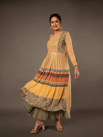A joyful, twirling shot of a model in a multi-layered Anarkali dress. This captures the movement and flow of the fabric, perfect for a fun and festive collection.