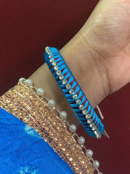 Explore my range of blue silk thread bangles, featuring different styles with kundan stones, coins, and pearl embellishments.