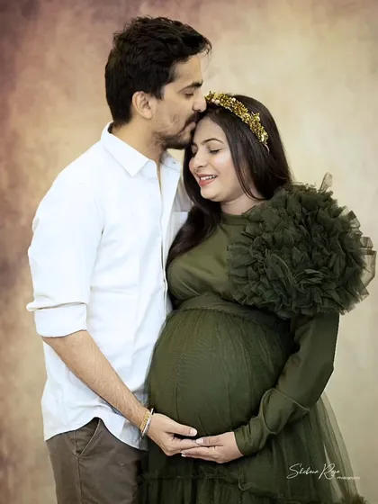I love capturing the quiet connection between couples before their new journey begins. This tender moment, with a gentle forehead kiss, shows the love and anticipation that fills the air during a couple's maternity shoot.