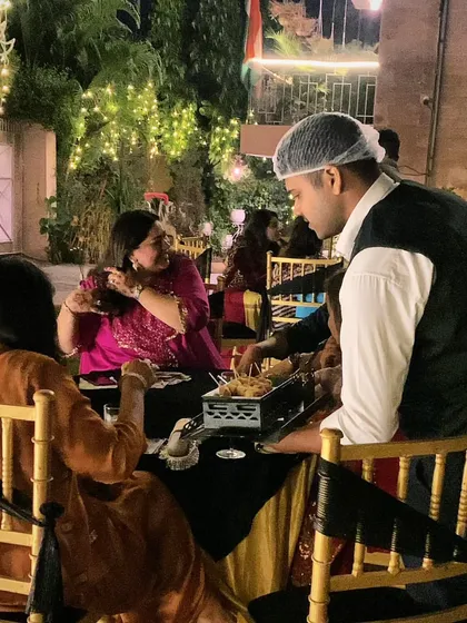 My attentive staff serving snacks directly to guests at their tables. This personalized service is perfect for evening parties and ensures everyone feels well-cared for.