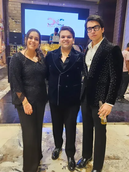 The brothers and founders of The Closet, Nikhil and Saksham, at an event. I'm wearing a black velvet blazer with scattered crystal embellishments for a subtle yet festive look.