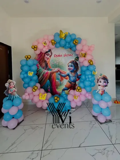 A decoration for a "Dohale Jevan" or traditional baby shower ceremony, with a custom backdrop featuring Yashoda and Krishna.