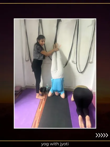 Assisting a student in Vrishchik Asana (Scorpion Pose). This advanced inversion strengthens the arms, shoulders, and core while improving spinal flexibility.