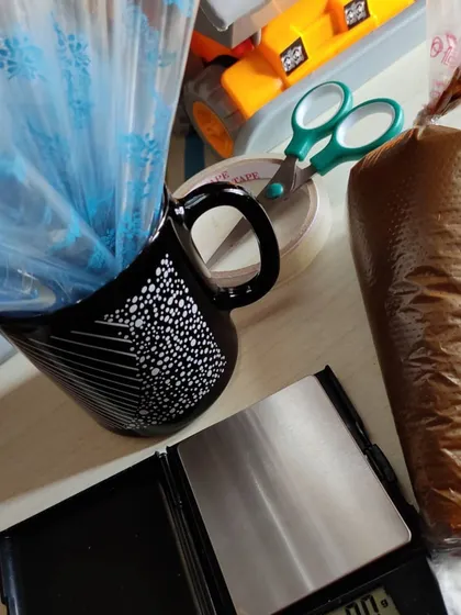 My henna-making station. You can see the piping bag filled with fresh paste, a weighing scale for precision, and empty cones ready to be filled.