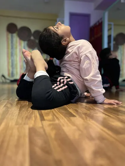 This student works on her backbend, demonstrating great progress in her spinal flexibility. We ensure all such movements are learned safely to protect the body.