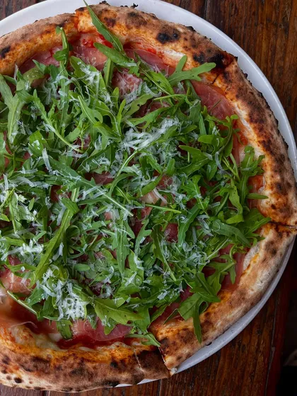 Hot from the oven, our Parma Ham & Arugula pizza is made for slow moments and good company. The saltiness of the ham pairs perfectly with the fresh, peppery arugula.