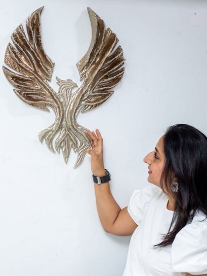 Placing "The Eternal Flight" on the wall. This hawk sculpture, titled "The Bronze Guardian," is a symbol of strength and resilience.