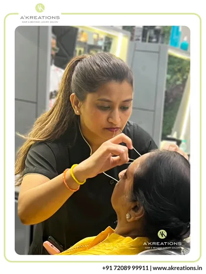 Precision is at the heart of our eyebrow threading service. Here, one of our expert aestheticians is meticulously shaping a client's brows to create a clean, defined arch that beautifully frames the face. We use gentle techniques to ensure a comfortable experience and perfectly sculpted results.