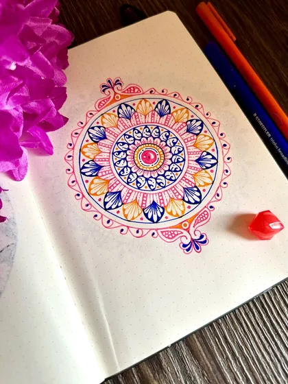 A playful and colorful design drawn in my journal. This piece features a bright palette of pink, blue, and orange, framed with decorative flourishes that give it a touch of elegance.