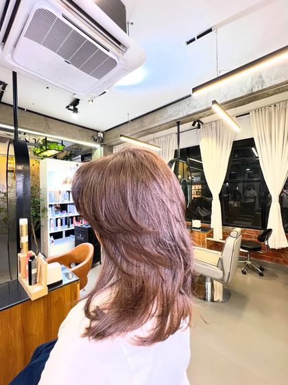 A slightly different angle of the absolute brown color, showing its even application and healthy shine under the salon lights.