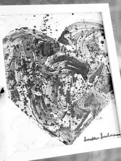 A duplicate shot of the framed black and white heart, emphasizing its graphic and emotional impact.
