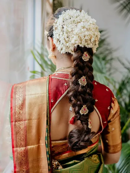 A super quick hair change for an afternoon reception, this traditional South Indian braid with a jasmine gajra is both classic and stunning.