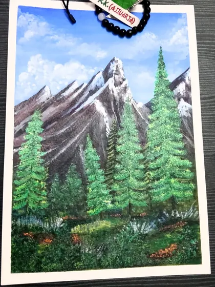 An acrylic painting of majestic, snow-capped mountains and lush pine trees. I used 200gsm paper for this piece to handle the layers of acrylic paint and capture the rugged texture of the landscape.