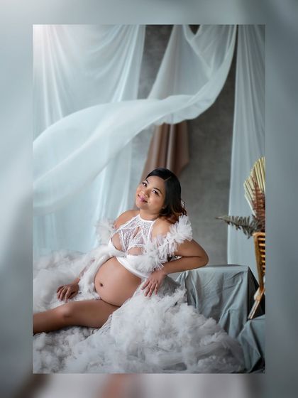 A dreamy, reclining pose amidst soft fabrics, creating an image of pure serenity and grace.