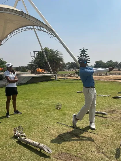 A player practices her swing under the watchful eye of a coach. The pristine condition of our practice facilities allows for quality training.