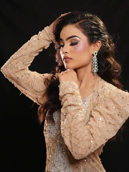 This pose highlights the soft, romantic waves in the hair and the shimmering highlight on the cheekbones.
