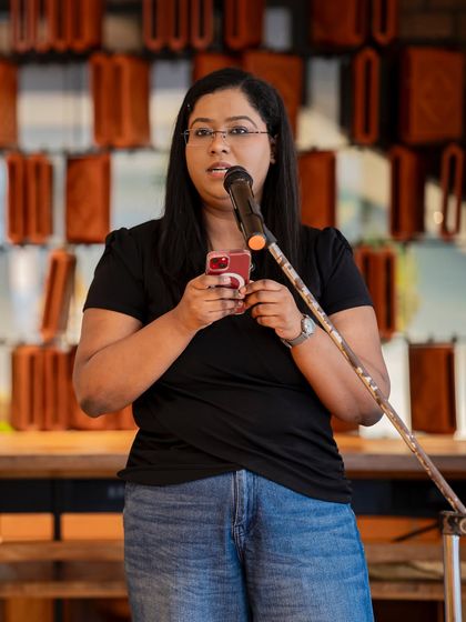 A performer reads her poem from her phone, a common sight at our modern poetry meetups. We believe poetry can be found anywhere, and our stage is open to all forms of expression.