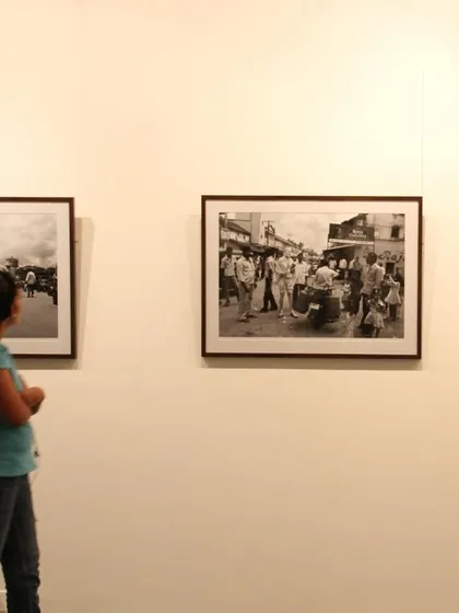 A visitor contemplates a series of black and white photographs from one of my earlier exhibitions, 'Face two Face'.
