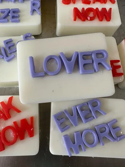 Taylor Swift-themed soaps featuring album titles like 'Lover' and 'Evermore', perfect for a Swiftie's party.