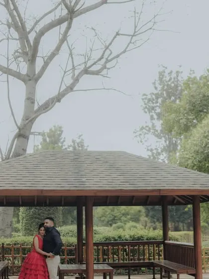 A wide shot capturing the serene atmosphere of a garden gazebo in Pune. This image showcases how I use the environment to frame a couple, creating a sense of privacy and romance in a grander setting.