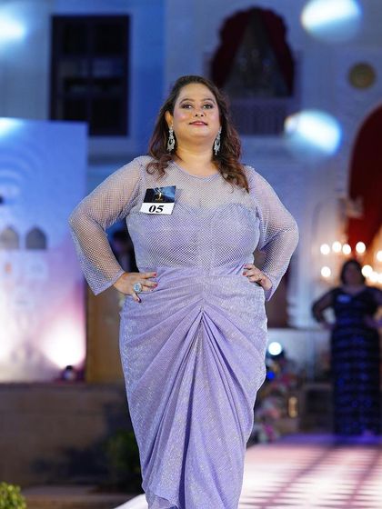 A soft lavender plus-size gown with a ruched bodice. The color and design are soft, romantic, and beautiful.