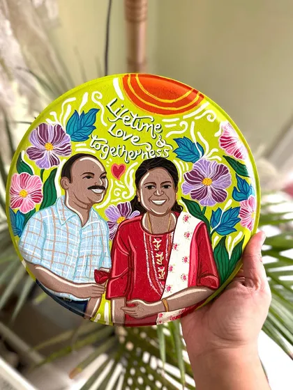 A beautiful anniversary plate celebrating a lifetime of love together, featuring a couple's portrait surrounded by hand-painted flowers.