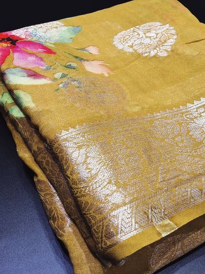 This olive green viscose saree combines a traditional zari border with a modern digital floral print. It's a unique and elegant piece that is sure to turn heads.