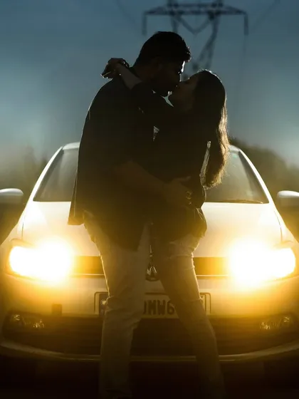 Proving that any location can be a perfect backdrop. This intimate silhouette was created using only the car's headlights for a moody and modern pre-wedding photograph.
