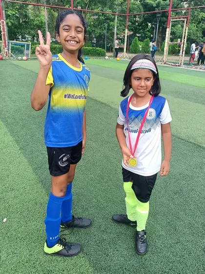 Peace and victory. Two teammates celebrating their success and the bond they share.