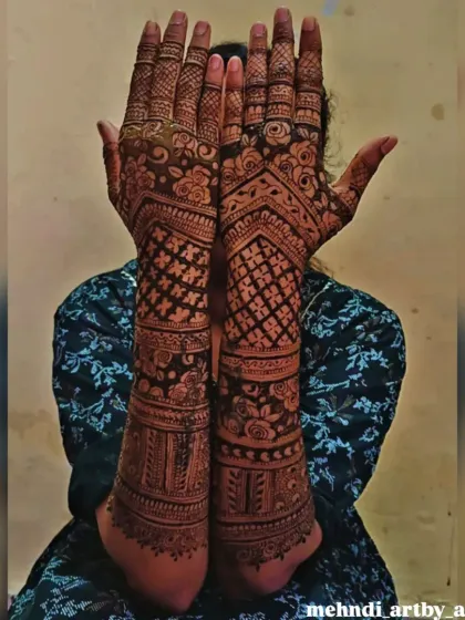Here is a full bridal mehendi design after the henna paste has been applied. The dense application, from fingertips to elbows, ensures a rich, dark stain, which is what every bride hopes for.