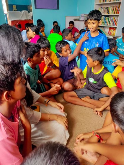 A group of boys actively participates in a story session. We create dynamic and engaging environments to hold their attention and spark their imagination.